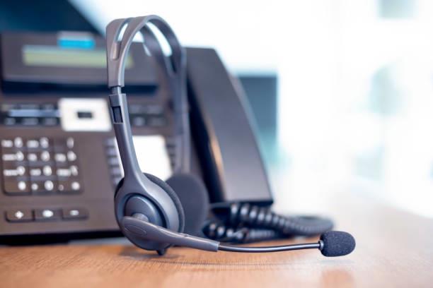 VOIP headset beside office phone